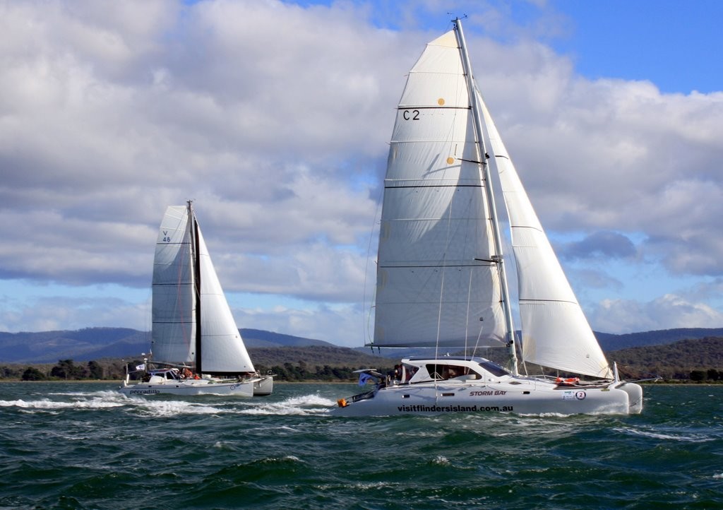 Hobart catamaran VisitFlindersIsland.com.au leads Peccadillo down the Tamar - Australian Three Peaks Race 2011 © Kate Phibbs